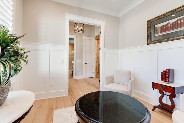 1036 Wilderness Way, Cottontown, TN 37048 - living area featuring a decorative wall, light wood-style floors, wainscoting, ornamental molding, and a chandelier