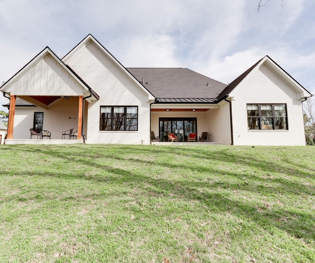1036 Wilderness Way, Cottontown, TN 37048 - rear view of property with a standing seam roof, brick siding, a lawn, a patio area, and a metal roof