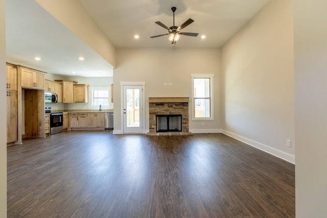 1189 Goose Dr, Springfield, TN 37172 - unfurnished living room featuring a stone fireplace, a ceiling fan, dark wood-style floors, and recessed lighting