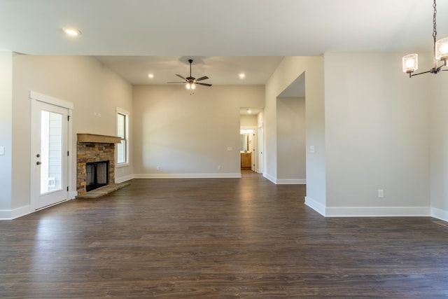 1189 Goose Dr, Springfield, TN 37172 - unfurnished living room with a chandelier, a ceiling fan, dark wood-style flooring, recessed lighting, and a fireplace