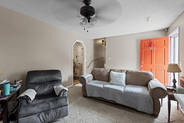 460 E Georgia Ave, Whitwell, TN 37397 - carpeted living room with arched walkways, ceiling fan, and a textured ceiling