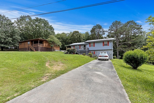 460 E Georgia Ave, Whitwell, TN 37397 - view of front of home featuring stairway, concrete driveway, and a front yard
