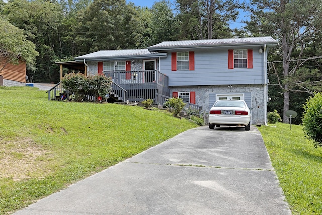 460 E Georgia Ave, Whitwell, TN 37397 - tri-level home featuring covered porch, driveway, a front yard, and a metal roof