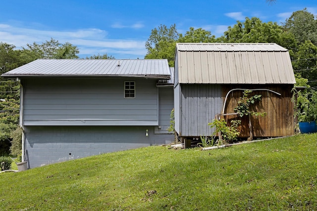 460 E Georgia Ave, Whitwell, TN 37397 - view of side of home featuring a lawn and a metal roof