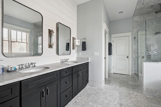 1711 Sevier St, Nashville, TN 37206 - bathroom with a shower stall, double vanity, and marble look tile flooring