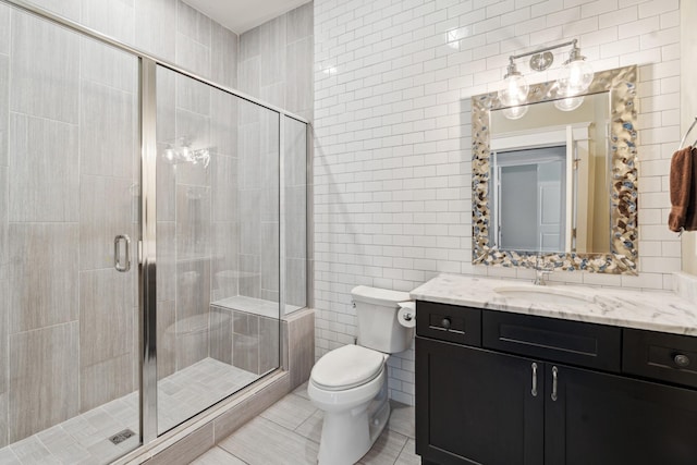 1711 Sevier St, Nashville, TN 37206 - full bathroom with tile walls, vanity, a shower stall, and tile patterned floors