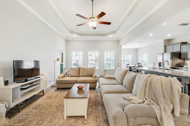 2122 Oak Dr, Murfreesboro, TN 37128 - living area featuring a ceiling fan, light wood finished floors, crown molding, recessed lighting, and a tray ceiling