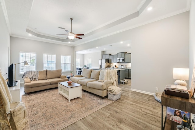 2122 Oak Dr, Murfreesboro, TN 37128 - living room featuring a raised ceiling, a ceiling fan, light wood-style flooring, crown molding, and recessed lighting