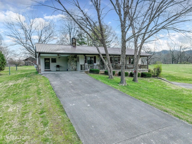 311 E Chestnut Hill Rd, Townsend, TN 37882 - view of front facade with driveway, covered porch, a chimney, a front lawn, and a metal roof