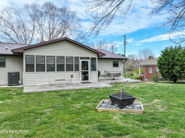 311 E Chestnut Hill Rd, Townsend, TN 37882 - rear view of house with an outdoor fire pit, a patio, a lawn, and a metal roof
