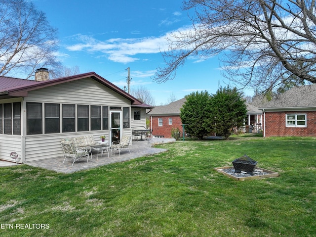 311 E Chestnut Hill Rd, Townsend, TN 37882 - view of grassy yard with an outdoor fire pit, a patio, and a sunroom