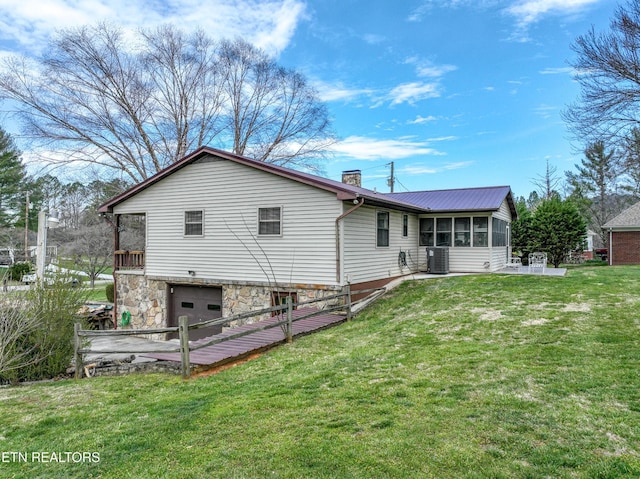 311 E Chestnut Hill Rd, Townsend, TN 37882 - rear view of property with a sunroom, an attached garage, a chimney, and a yard
