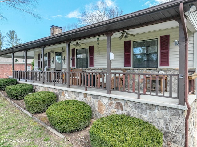 311 E Chestnut Hill Rd, Townsend, TN 37882 - view of front of home featuring a porch, a ceiling fan, a chimney, and stone siding