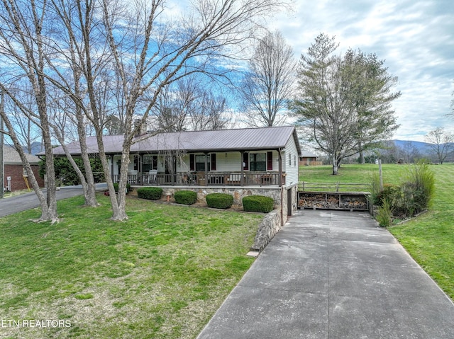 311 E Chestnut Hill Rd, Townsend, TN 37882 - ranch-style house featuring a porch, asphalt driveway, a front yard, a metal roof, and stone siding