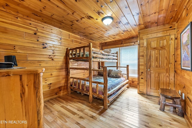 1615 Mountain Dreams Way, Sevierville, TN 37862 - bedroom featuring wood walls, wooden ceiling, and light wood-style floors