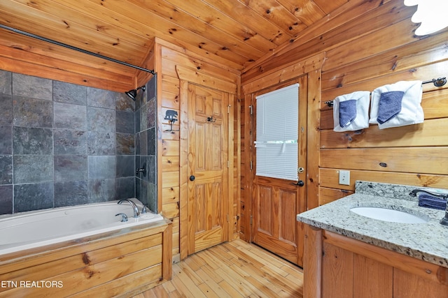 1615 Mountain Dreams Way, Sevierville, TN 37862 - bathroom featuring vanity, washtub / shower combination, hardwood / wood-style flooring, and wood walls