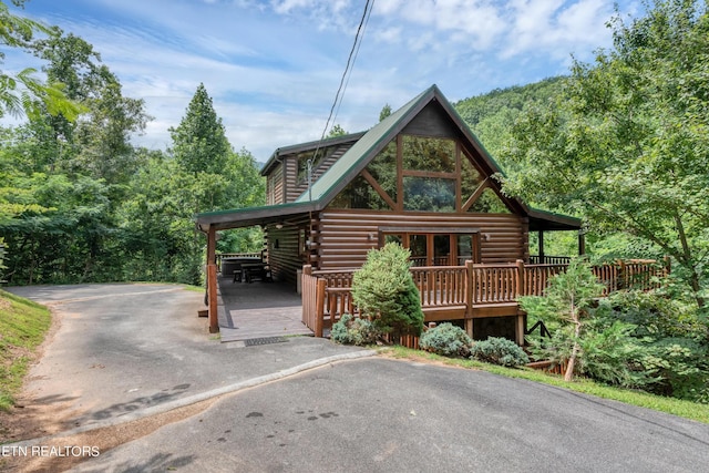1615 Mountain Dreams Way, Sevierville, TN 37862 - log cabin with log siding, a deck, and driveway