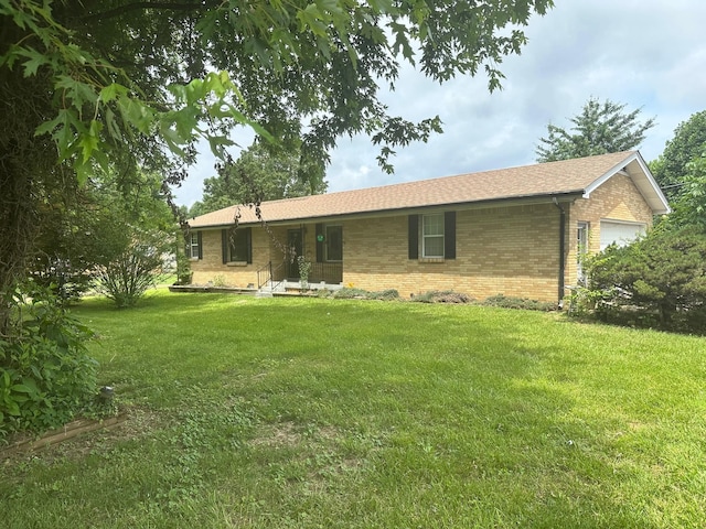 233 Flat Ridge Rd, Goodlettsville, TN 37072 - view of front of house featuring brick siding, a front yard, an attached garage, and roof with shingles
