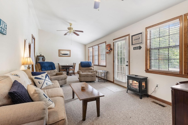 1795 Lake Logan Rd, Ardmore, TN 38449 - living room featuring ceiling fan, a wood stove, light colored carpet, and vaulted ceiling