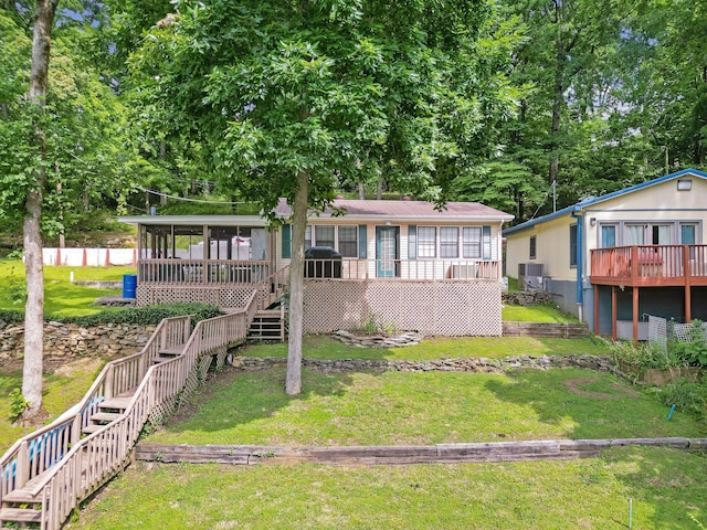 1795 Lake Logan Rd, Ardmore, TN 38449 - view of front of property featuring stairway, a front lawn, a sunroom, and a wooden deck