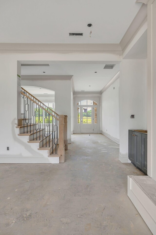 5414 Old Salem Rd, Rockvale, TN 37153 - unfurnished living room featuring unfinished concrete floors, stairway, and arched walkways