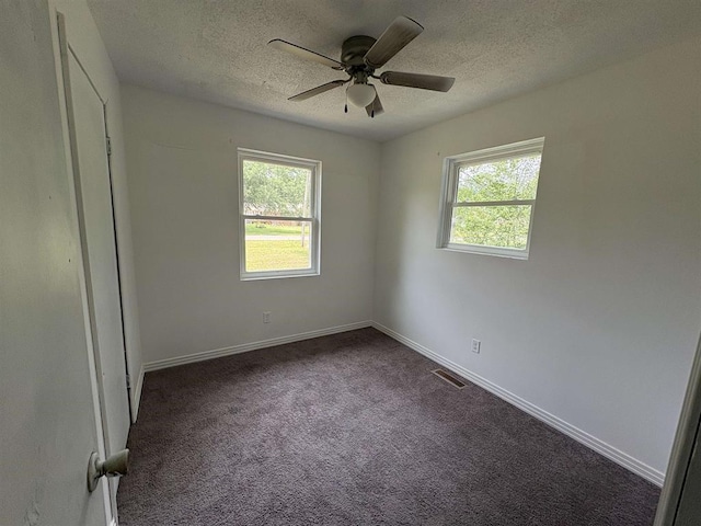 265 Garey Loop Unit 11, Savannah, TN 38372 - unfurnished bedroom with a textured ceiling, dark colored carpet, and ceiling fan