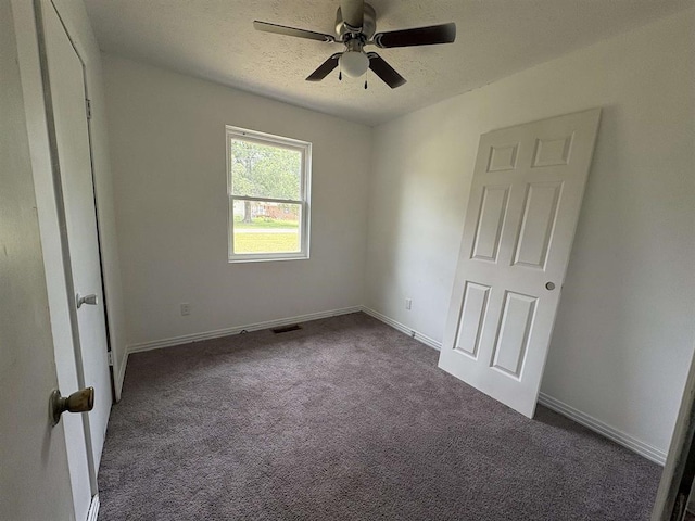 265 Garey Loop Unit 11, Savannah, TN 38372 - unfurnished bedroom featuring dark colored carpet, ceiling fan, and a textured ceiling