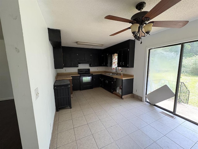 265 Garey Loop Unit 11, Savannah, TN 38372 - kitchen with black range, dark cabinets, light countertops, and a textured ceiling