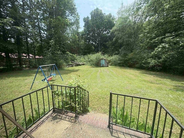 265 Garey Loop Unit 11, Savannah, TN 38372 - view of green lawn with a playground and a storage unit