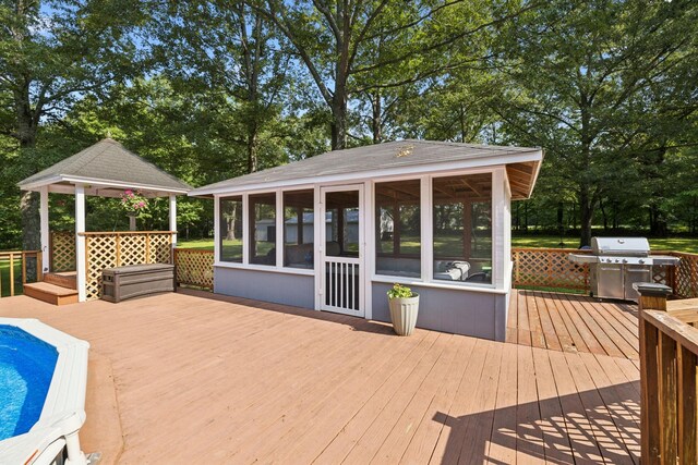 7180 Elrod Rd, Fairview, TN 37062 - wooden terrace with a sunroom, a gazebo, an outdoor pool, area for grilling, and view of scattered trees