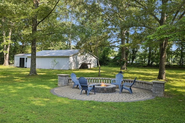 7180 Elrod Rd, Fairview, TN 37062 - view of green lawn with a fire pit, an outbuilding, a patio, and a pole building