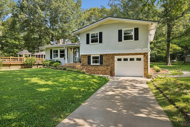 7180 Elrod Rd, Fairview, TN 37062 - split level home with an attached garage, concrete driveway, and a front lawn