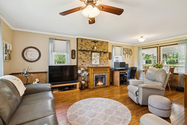7180 Elrod Rd, Fairview, TN 37062 - living area with crown molding, wood finished floors, a fireplace, ceiling fan, and an office area