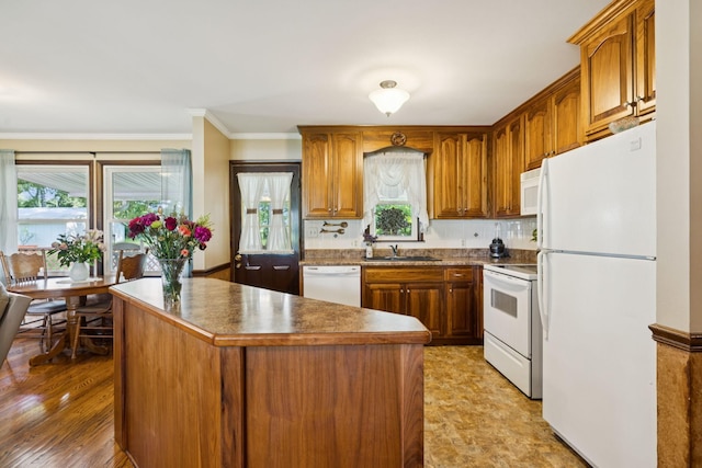 7180 Elrod Rd, Fairview, TN 37062 - kitchen with white appliances, plenty of natural light, crown molding, brown cabinets, and a center island