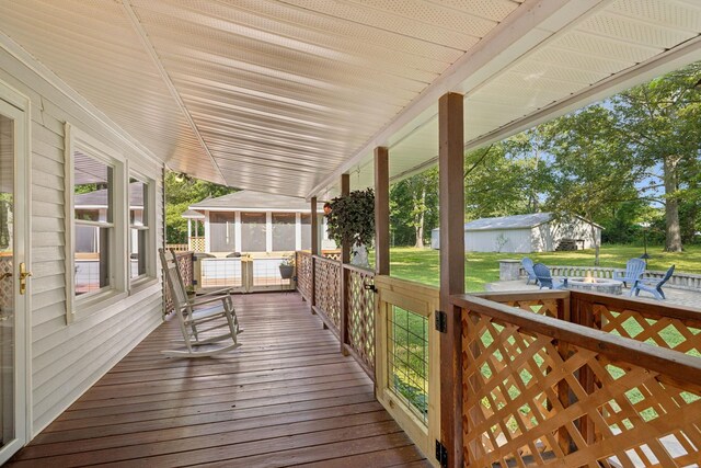 7180 Elrod Rd, Fairview, TN 37062 - wooden terrace featuring a sunroom, a fire pit, and a yard