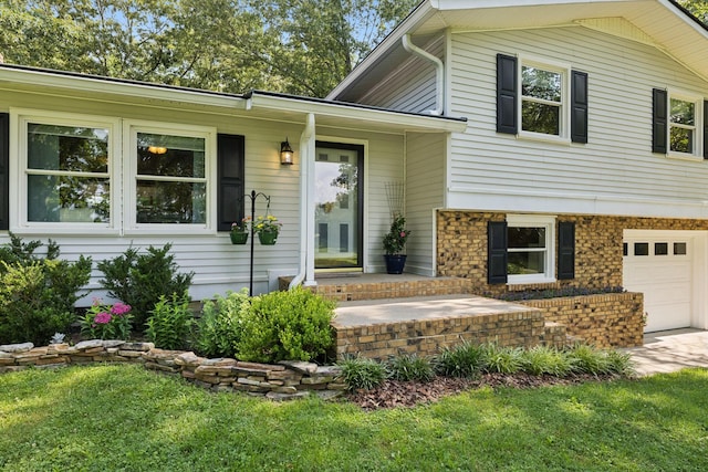 7180 Elrod Rd, Fairview, TN 37062 - view of exterior entry with an attached garage, a lawn, and driveway