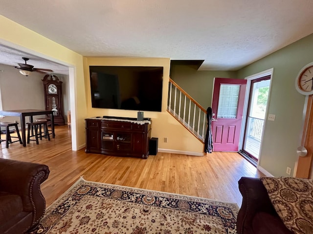 4038 Mount Zion Rd, Morrison, TN 37357 - living area with wood finished floors, stairway, and a textured ceiling