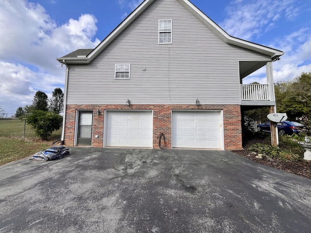 4038 Mount Zion Rd, Morrison, TN 37357 - view of home's exterior featuring an attached garage, brick siding, and asphalt driveway