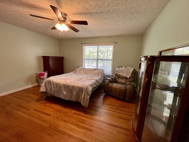 4038 Mount Zion Rd, Morrison, TN 37357 - bedroom with a textured ceiling, wood finished floors, and a ceiling fan