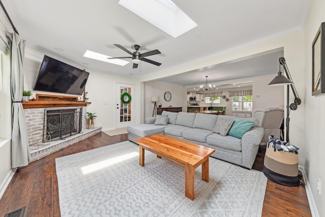1704 Christi Ave, Chapel Hill, TN 37034 - living room featuring a skylight, a fireplace, a chandelier, a ceiling fan, and crown molding