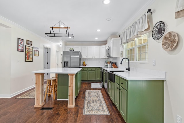 1704 Christi Ave, Chapel Hill, TN 37034 - kitchen with green cabinetry, stainless steel appliances, a breakfast bar, a center island, and dark wood finished floors
