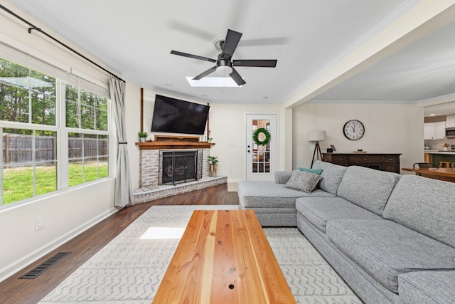 1704 Christi Ave, Chapel Hill, TN 37034 - living area featuring ceiling fan, plenty of natural light, a brick fireplace, dark wood-style flooring, and ornamental molding