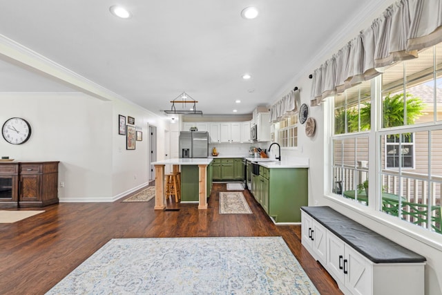1704 Christi Ave, Chapel Hill, TN 37034 - kitchen with stainless steel fridge, green cabinetry, a kitchen bar, dark wood-style floors, and crown molding