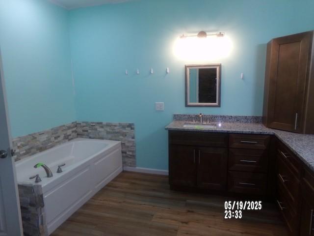 1835 Mosley Ferry Rd, Chapmansboro, TN 37035 - full bath with a garden tub, wood finished floors, and vanity
