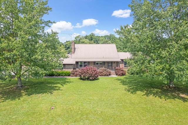 89 Belmar Cir, Manchester, TN 37355 - rear view of house with a chimney, a yard, and a metal roof