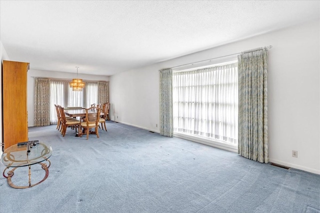 89 Belmar Cir, Manchester, TN 37355 - carpeted living room featuring a chandelier and baseboards