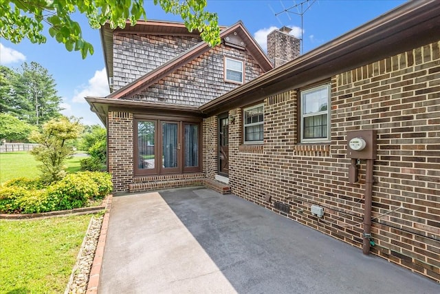 89 Belmar Cir, Manchester, TN 37355 - doorway to property featuring a patio area, a chimney, and brick siding
