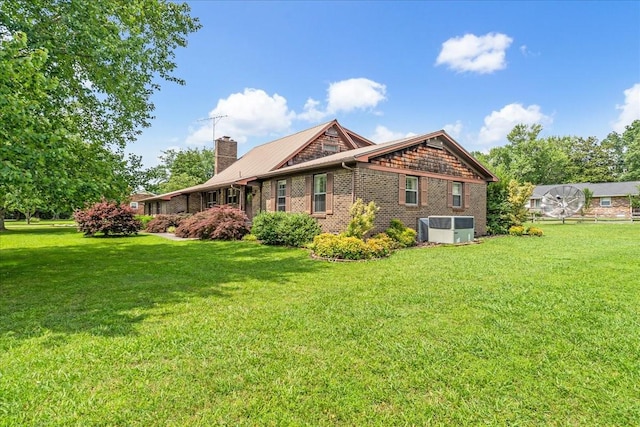 89 Belmar Cir, Manchester, TN 37355 - rear view of house with a lawn, a chimney, and brick siding