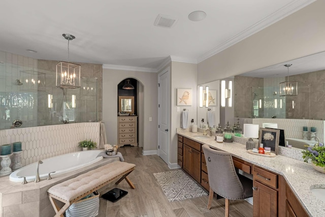 800 Singleton Ln, Brentwood, TN 37027 - full bathroom featuring a chandelier, vanity, a garden tub, a stall shower, and ornamental molding