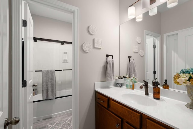 800 Singleton Ln, Brentwood, TN 37027 - bathroom with vanity, wood finished floors, and bath / shower combo with glass door